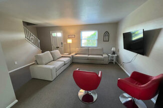 Livingroom with couches and chairs and tv
